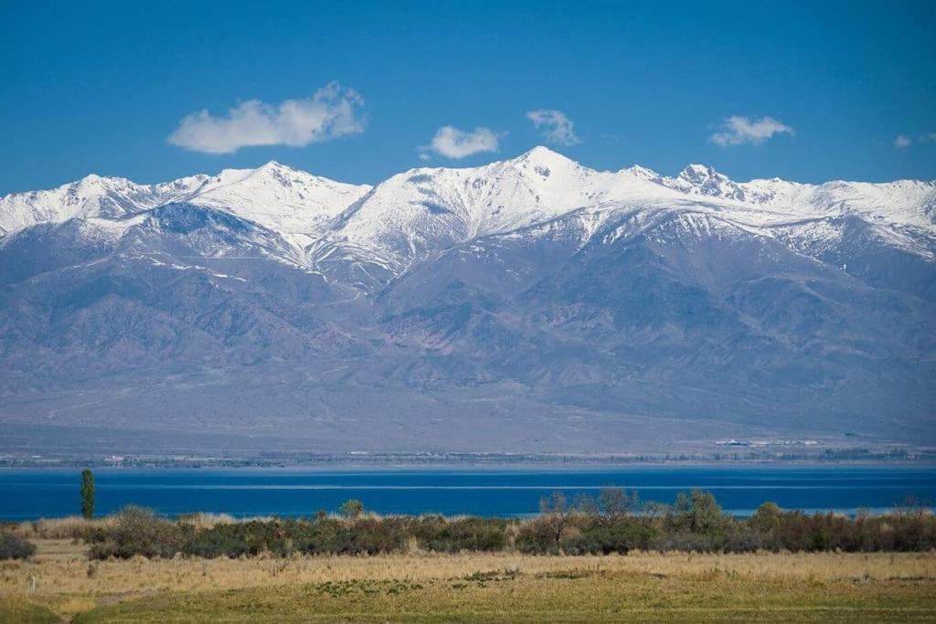 a snow covered mountain range with a body of water at Private Luxury Villa - Issyk Kul in Cholpon-Ata