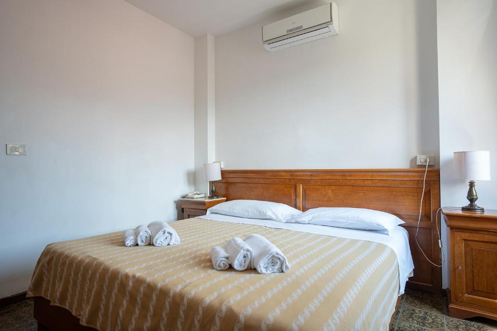 Postel nebo postele na pokoji v ubytování Hotel Napoleon