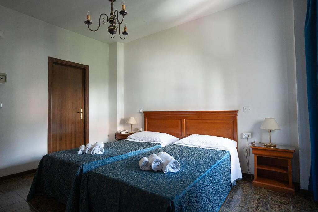Postel nebo postele na pokoji v ubytování Hotel Napoleon