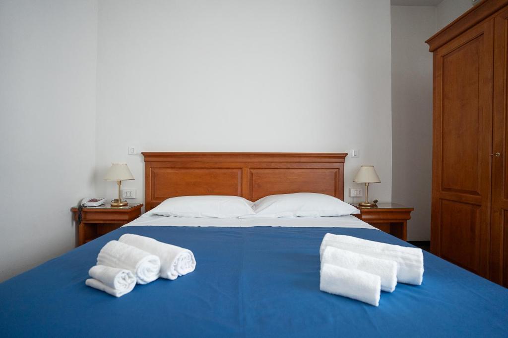 Postel nebo postele na pokoji v ubytování Hotel Napoleon