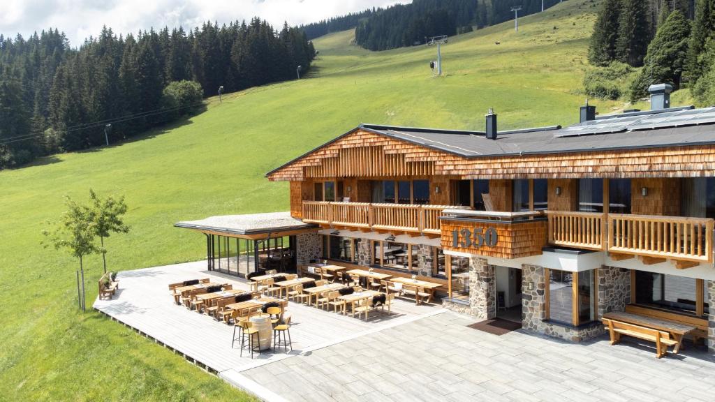 an aerial view of a log house with a patio at Die Alm 1350 in Saalbach Hinterglemm