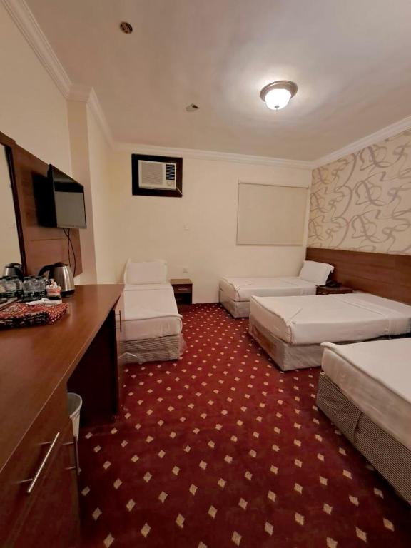 Postel nebo postele na pokoji v ubytování فندق كنان العزيزية Kinan Al Azizia Hotel Makkah