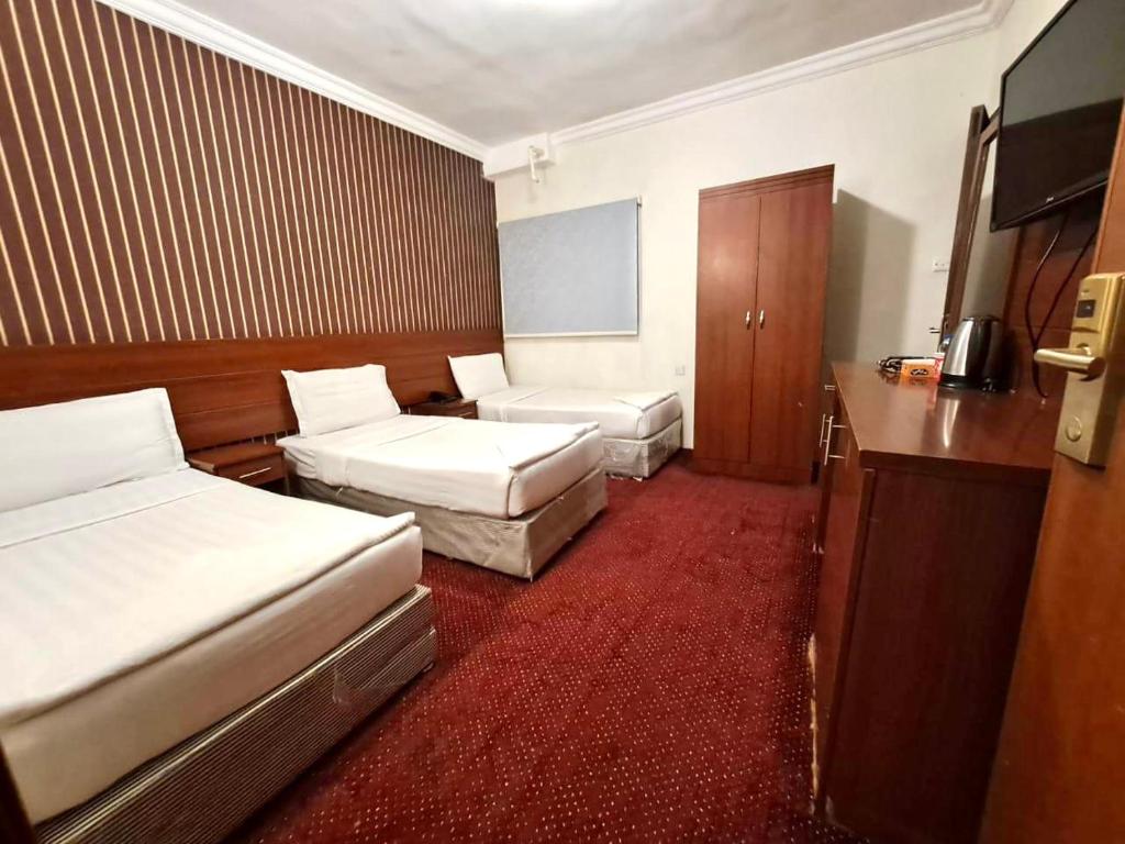 Postel nebo postele na pokoji v ubytování فندق كنان العزيزية Kinan Al Azizia Hotel Makkah