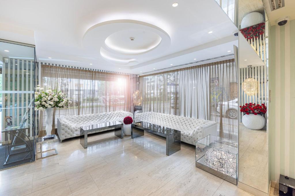 a lobby with two couches and flowers on the wall at Hotel 9 in Zagreb