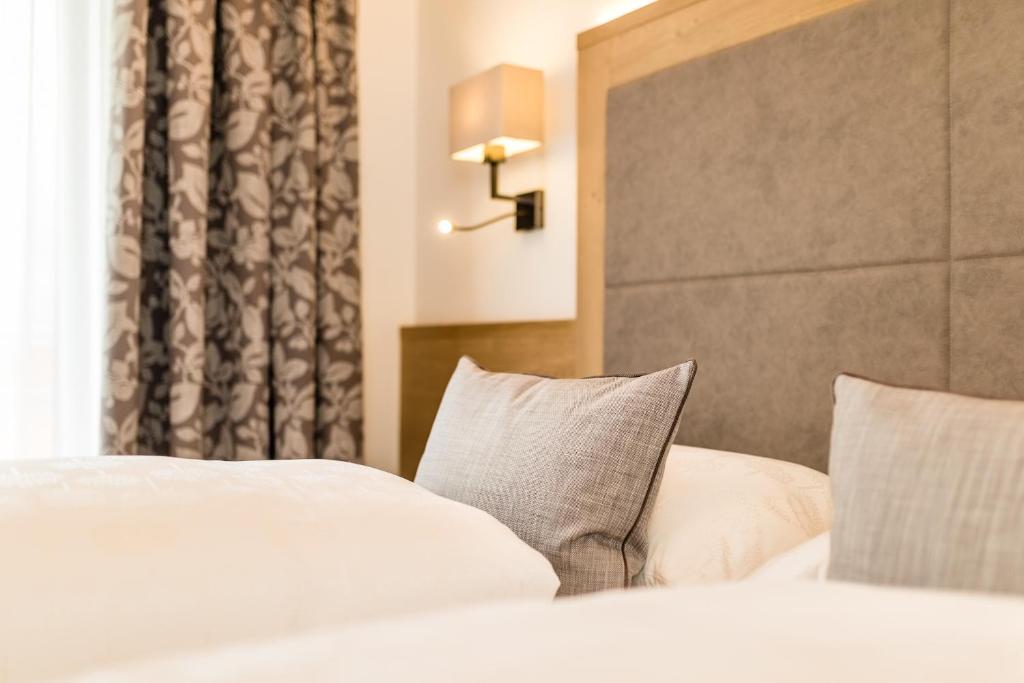 Postel nebo postele na pokoji v ubytování Garni Hotel Am Meilenstein