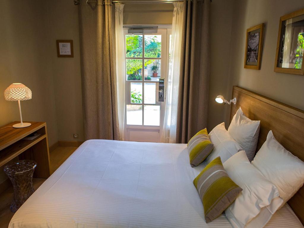 Postel nebo postele na pokoji v ubytování Hôtel La Caravelle
