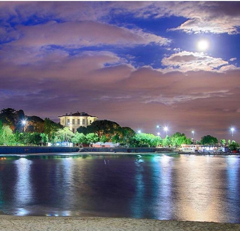 a view of a river at night with a building at Yıldız in Istanbul