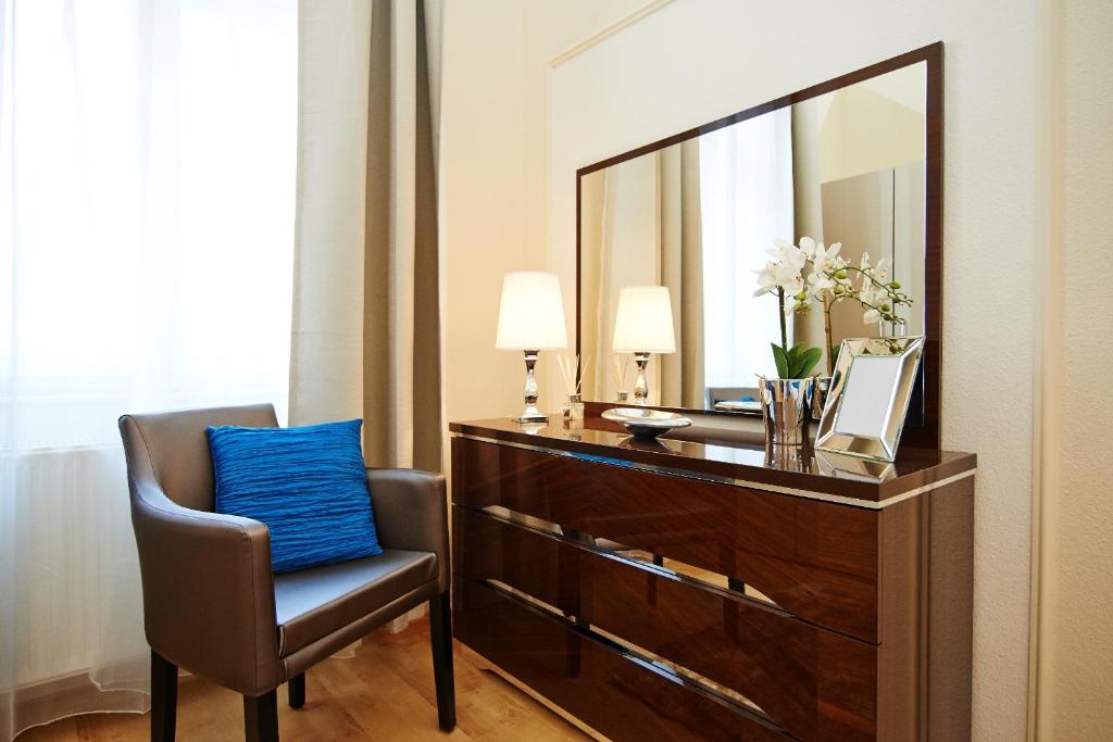 vestidor con espejo y silla en una habitación en Budapest Luxury Apartments, en Budapest