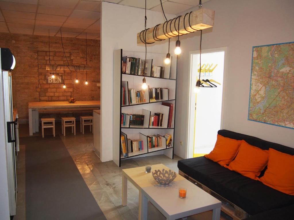 a living room with a couch and a book shelf at Box61 Art Concept Flat in Berlin