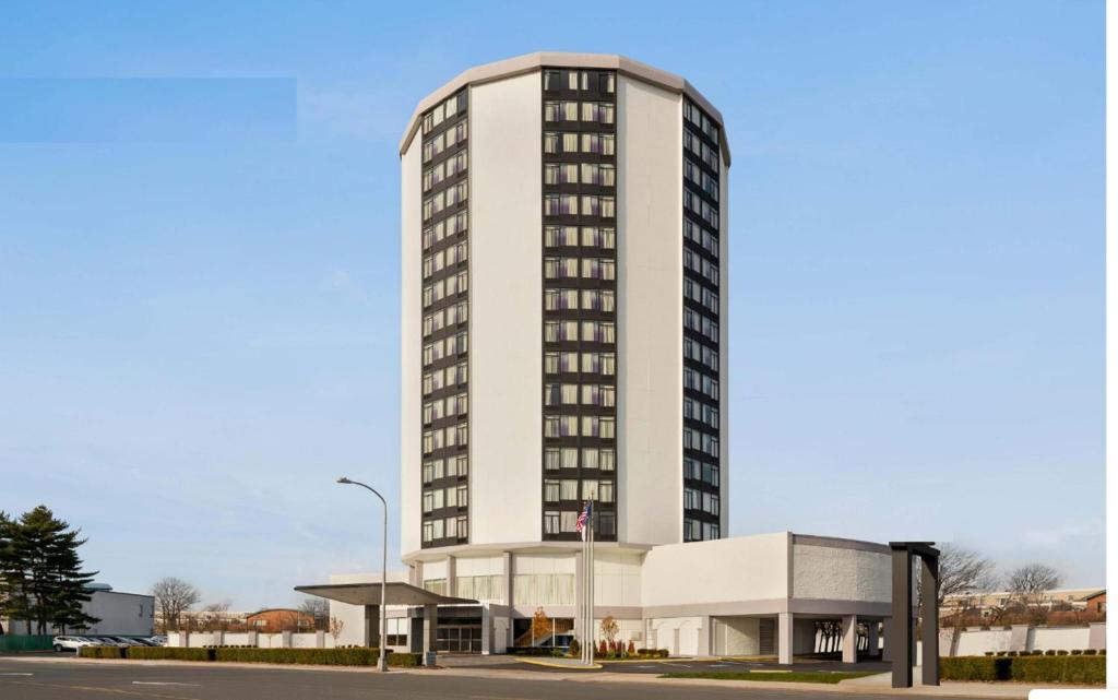 a tall white building with a building at Holiday Inn Philadelphia Arpt-Stadium Area, an IHG Hotel in Philadelphia