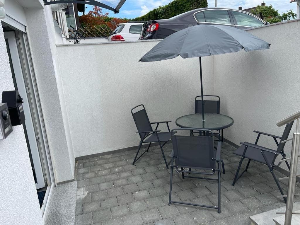 un tavolo e sedie con ombrellone su un patio di Erbacher Ferienwohnung 2 a Erbach