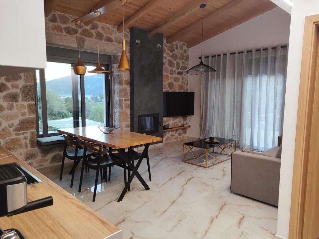 a kitchen and living room with a table and a couch at Luxury Villa Serani with Panoramic View in Vasiliki