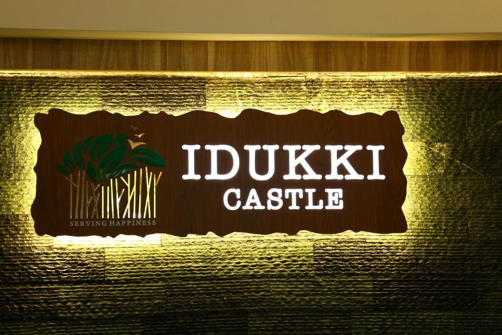 a sign for a dubiki castle on a wall at Hotel Idukki Castle in Idukki