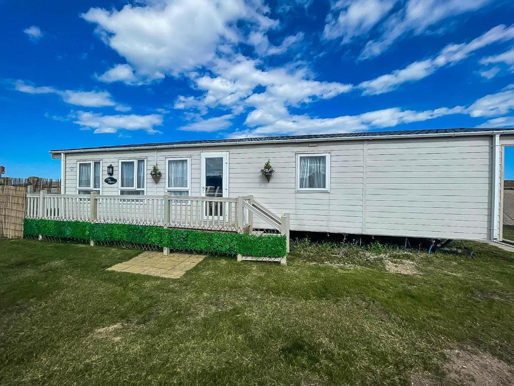 a large white house with a large yard at Lovely Caravan With Decking At North Denes Park In Suffolk, Ref 40050nd in Lowestoft