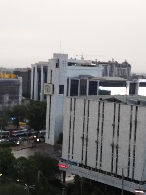 a tall white building with a clock tower in a city at Абдрахманова 176 in Bishkek