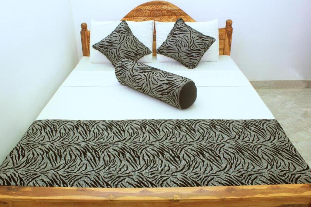 Postel nebo postele na pokoji v ubytování Keerthi Homestay