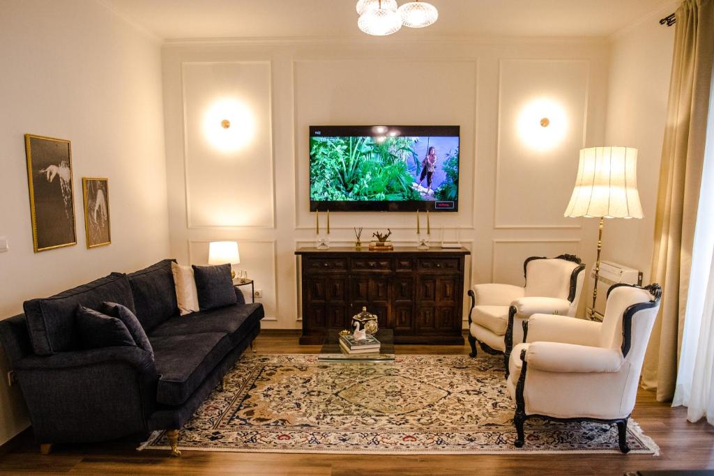 a living room with a couch and a flat screen tv at NOVI's Luxury Apartment 2 in Gjirokastër