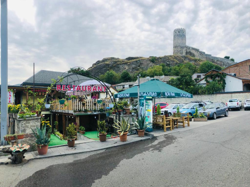 a market with tables and umbrellas on a street at Old Rabati in Akhaltsikhe