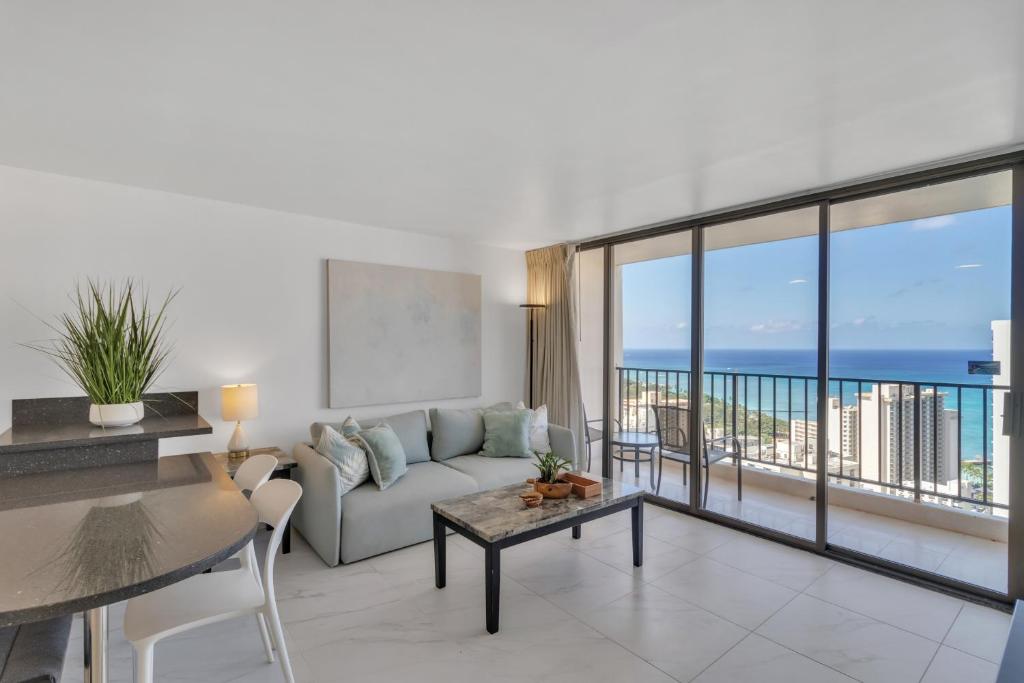 a living room with a couch and a view of the ocean at Standard Ocean View Condo - 36th Floor, Free parking & Wifi condo in Honolulu