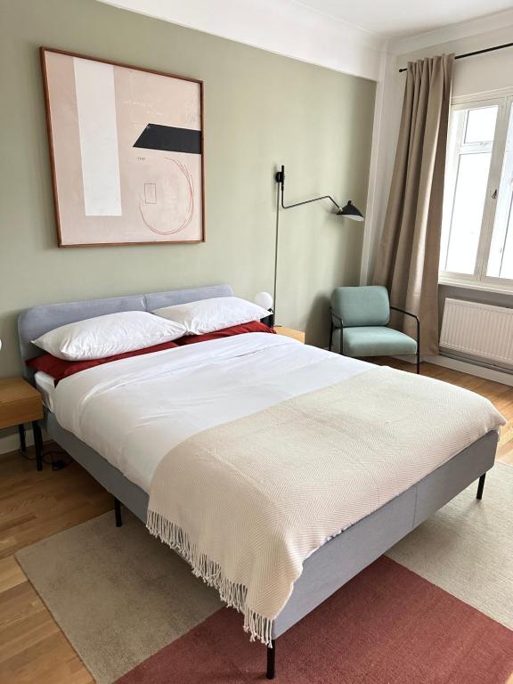 a bedroom with a large bed and a chair at Modernist Studio in Fitzrovia in London