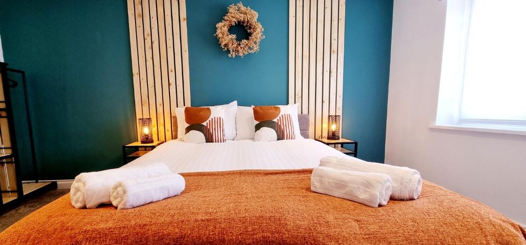 a bedroom with a large bed with towels on it at Bed& Boujee by the pier in Paignton