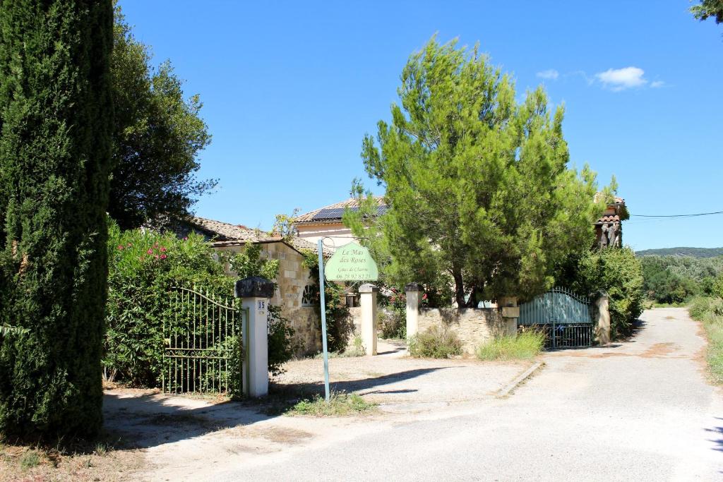 a house with a fence and trees on a street at NEW! Gîtes de Charme au Mas de Soleil in Goudargues