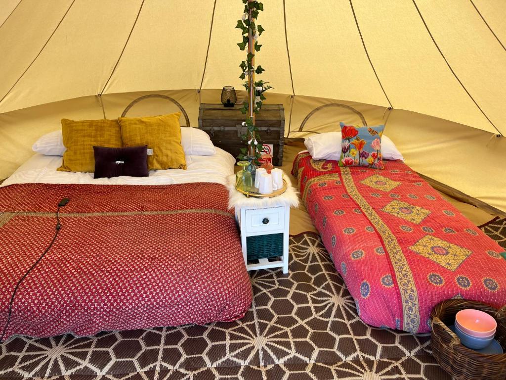 um quarto com 2 camas numa tenda em Hawthorne Field - Shoreline Escapes em Bransgore