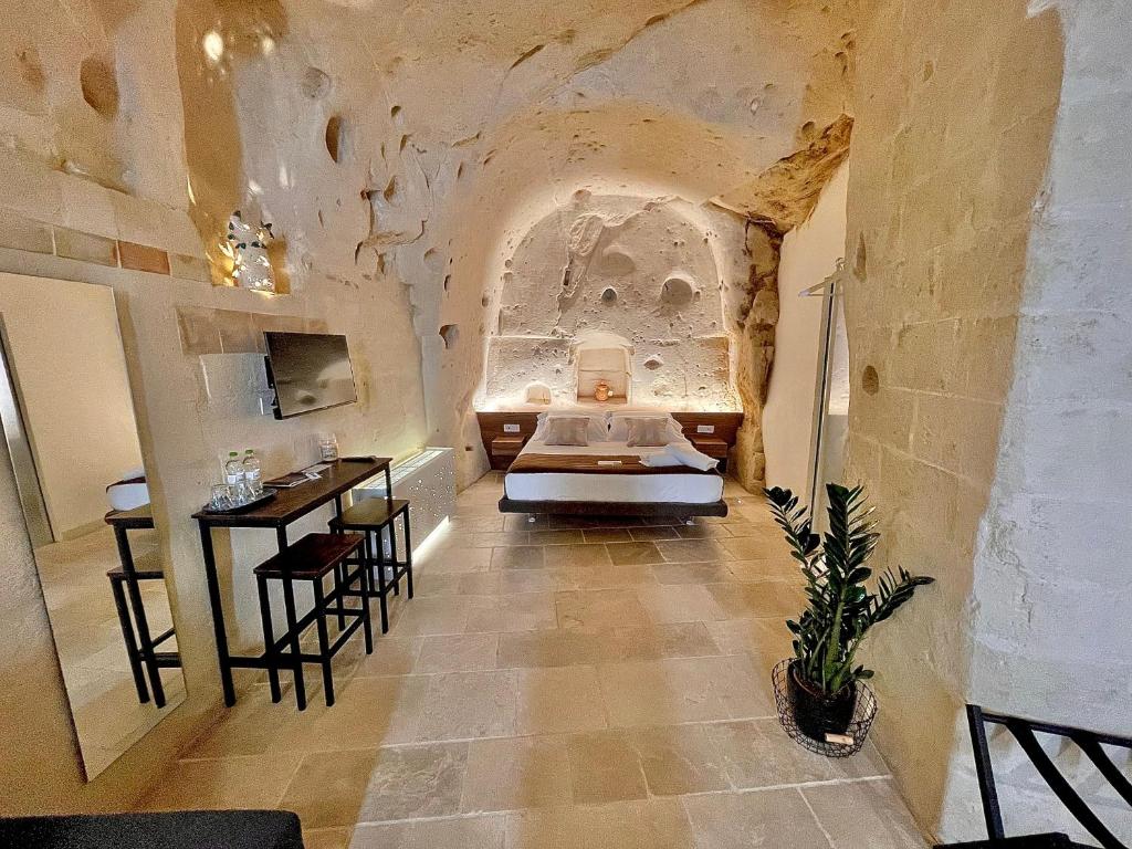 a room with a bed and a table and chairs at CASA VACANZE BB 164-166 in Matera