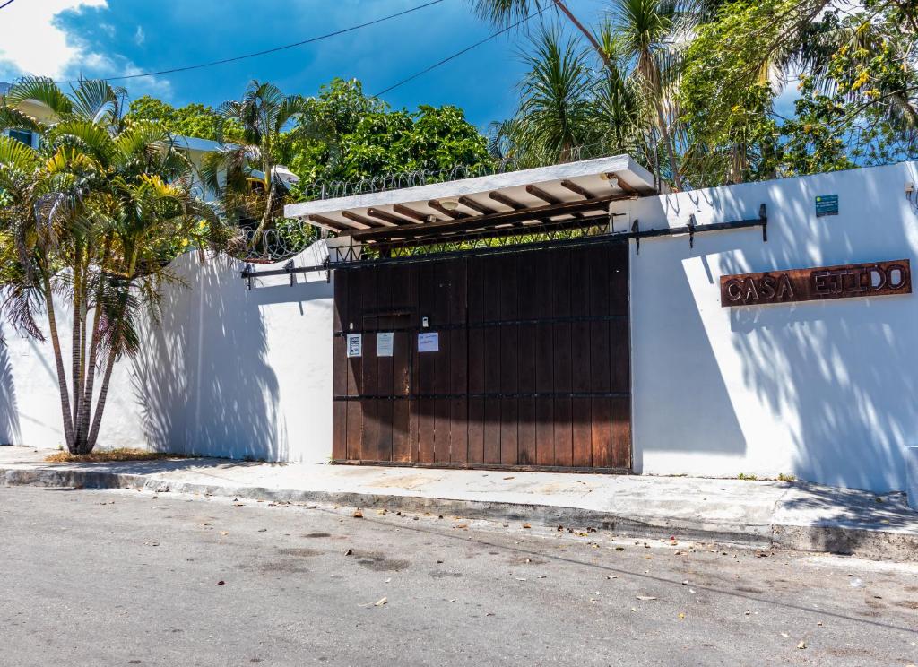 a building with a wooden door on the side of a street at Bed & Breakfast Casaejido in Playa del Carmen