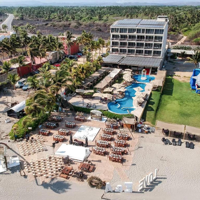 an aerial view of a resort with a pool and a building at Mishol Bodas Hotel & Beach Club Acapulco Diamante in Acapulco