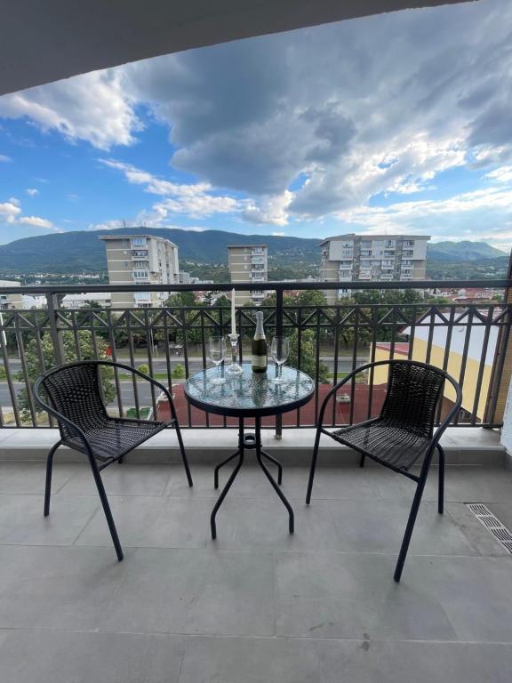 a table and two chairs on a balcony with a view at King Size Apartment in Skopje