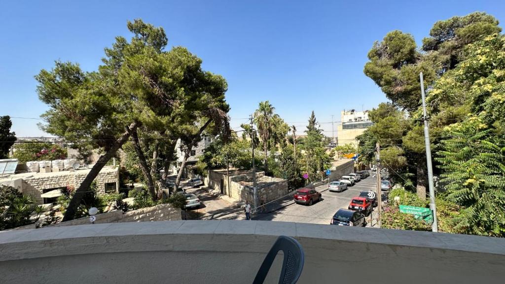 a view of a city street from a balcony at The vintage apartment in Amman