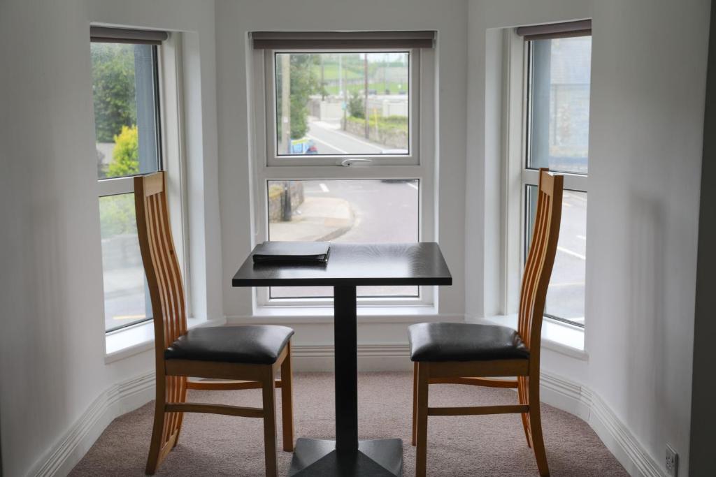 a table and two chairs in front of a window at The Landmark in Cork