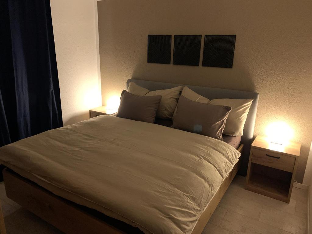 a bedroom with a large bed with two lamps at Apartment EigerView in Grindelwald