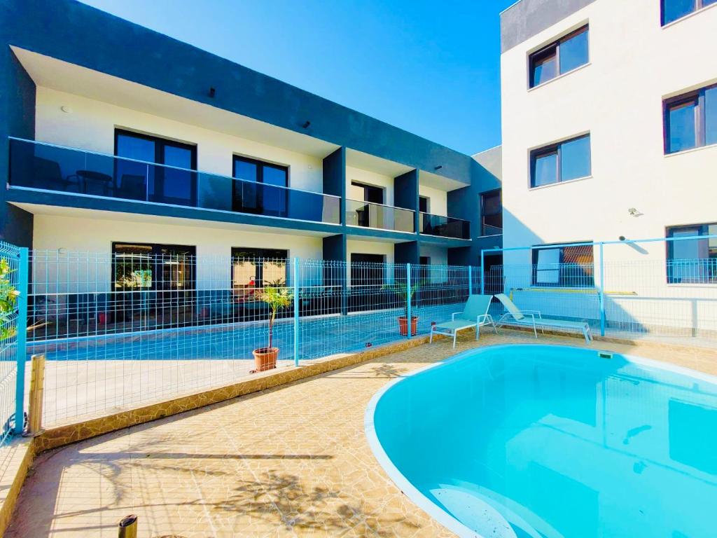 a building with a swimming pool in front of a building at Laguna Grey in Mangalia