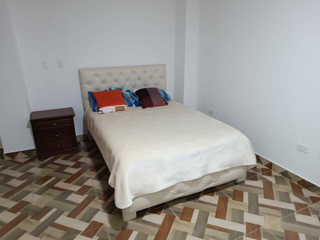 a bedroom with a bed and a wooden floor at Residencia Chamorro-Dorado in Quito