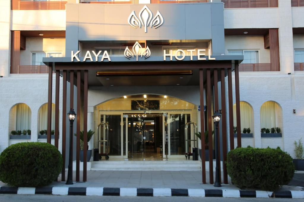 a hotel with a sign on the front of it at Kaya Hotel Amman in Amman