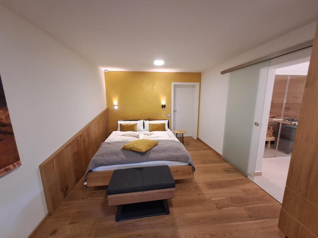 a bedroom with a large bed and a wooden floor at kleine Schwarzwaldlodge in Efringen-Kirchen