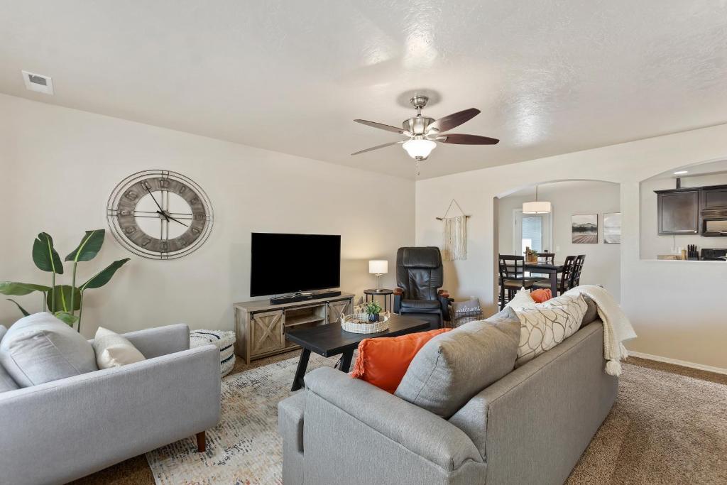 a living room with two couches and a flat screen tv at 4br Sleeps 9 Near Topgolf, Parks Wahooz Fun in Meridian