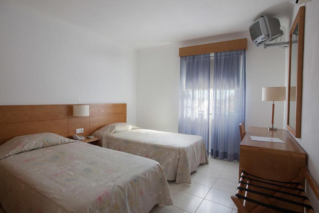 Postel nebo postele na pokoji v ubytování Hotel Solmar