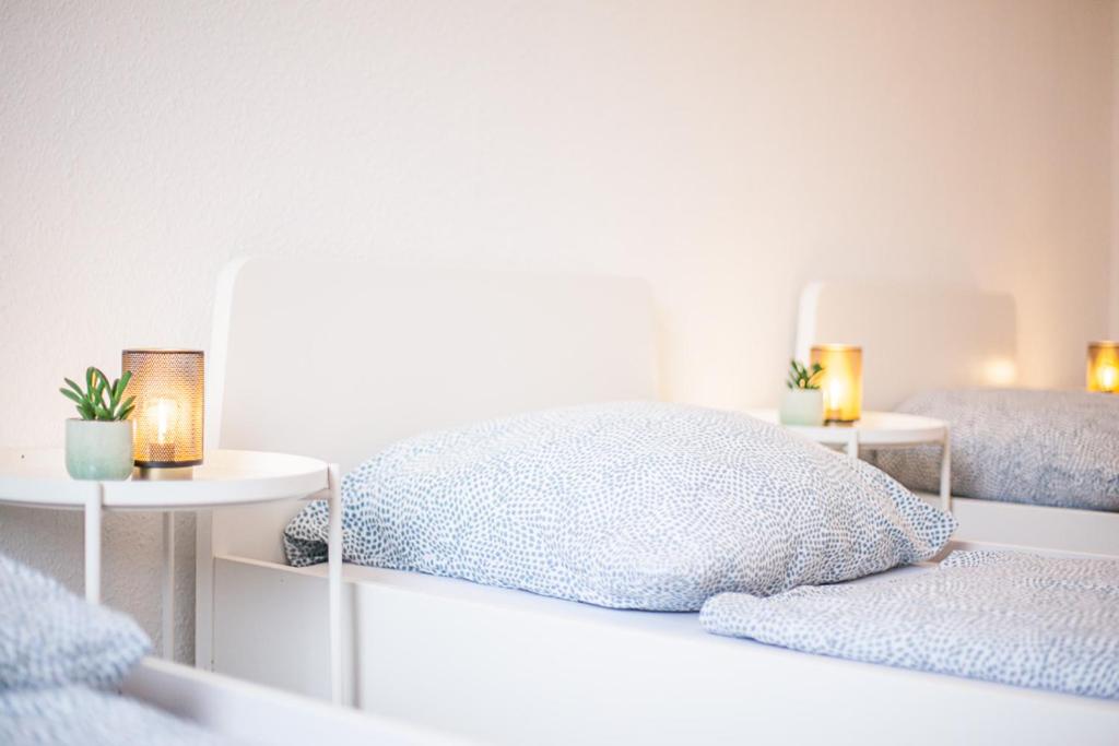 a bedroom with a bed and two tables with candles at DO One Bedroom Flat in Dortmund