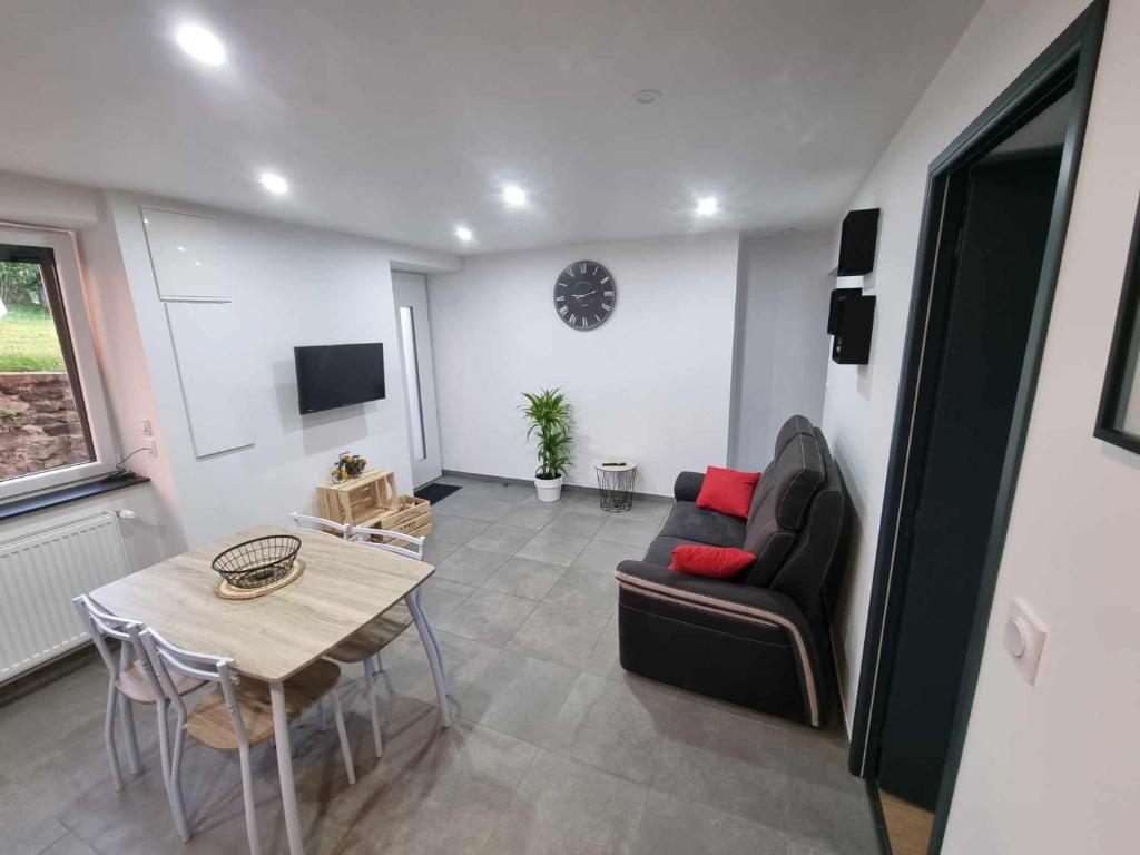 a living room with a couch and a table at Appartement le Crozatier in Saint-Georges