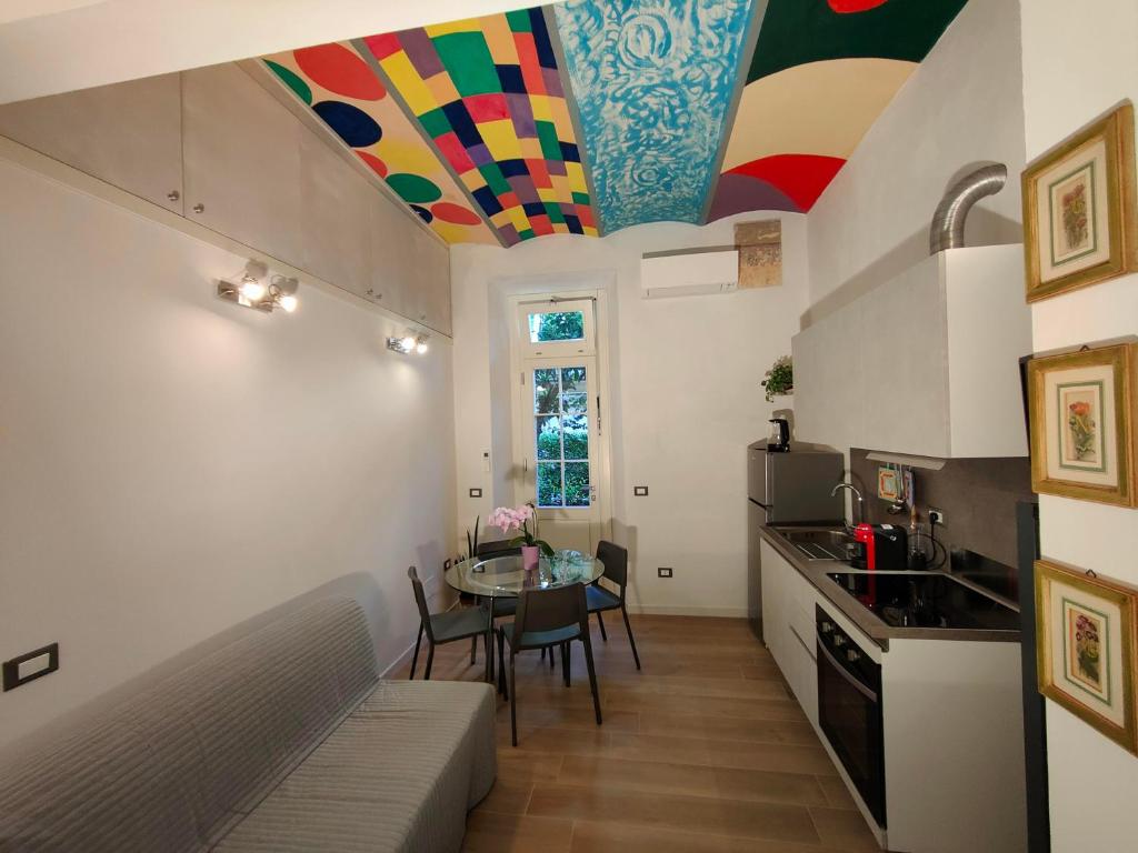 a kitchen with a table and a colorful ceiling at Discover Donatello - Fiorenza in Florence