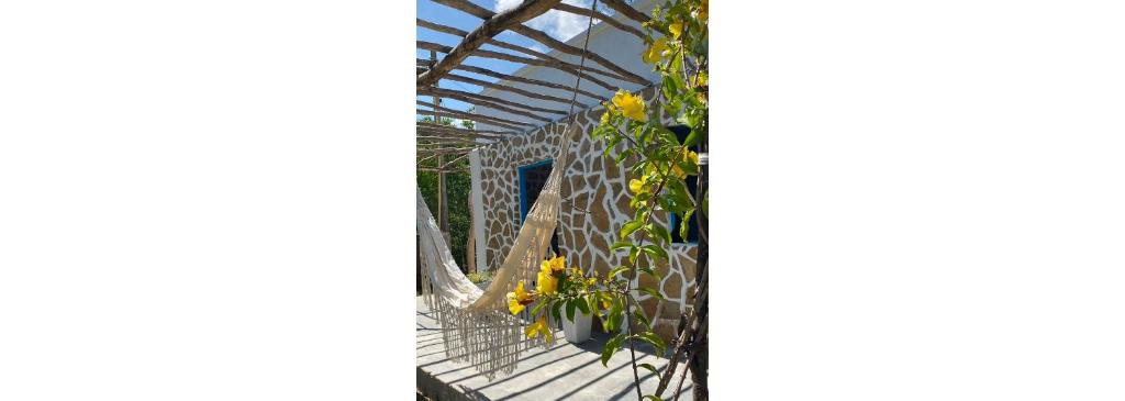 a glass greenhouse with yellow flowers on a balcony at Villa Mediterránea in Tubará