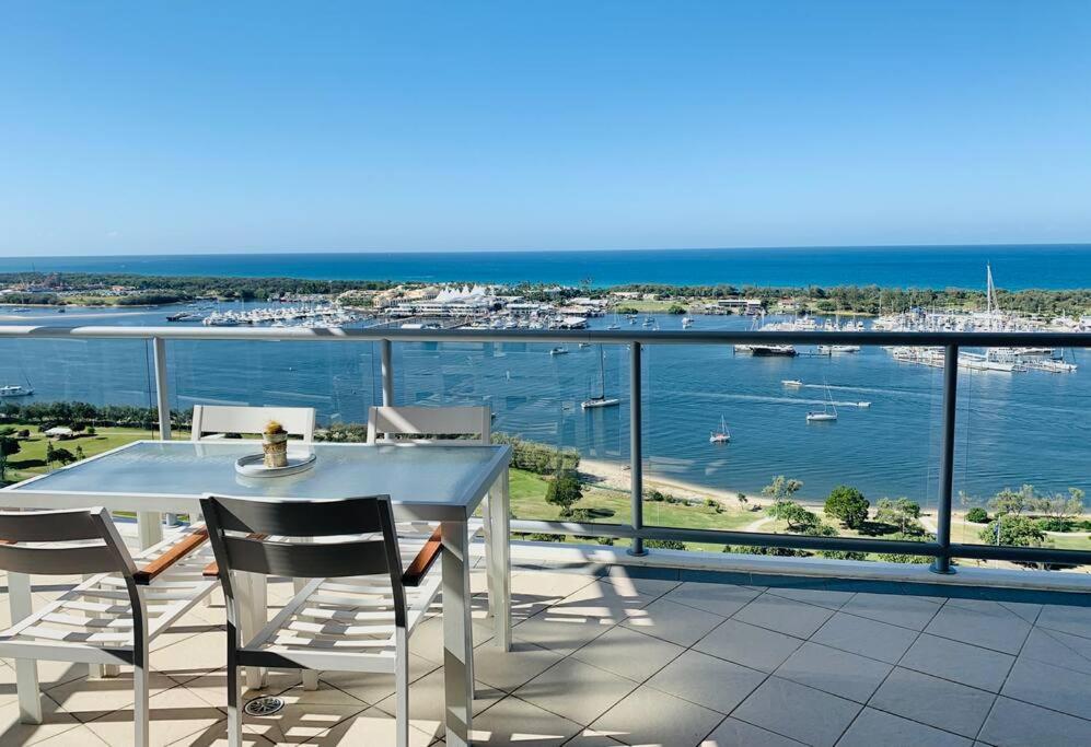 a table and chairs on a balcony with a view of the ocean at Southport Sea Views - Shores Apartment in Gold Coast