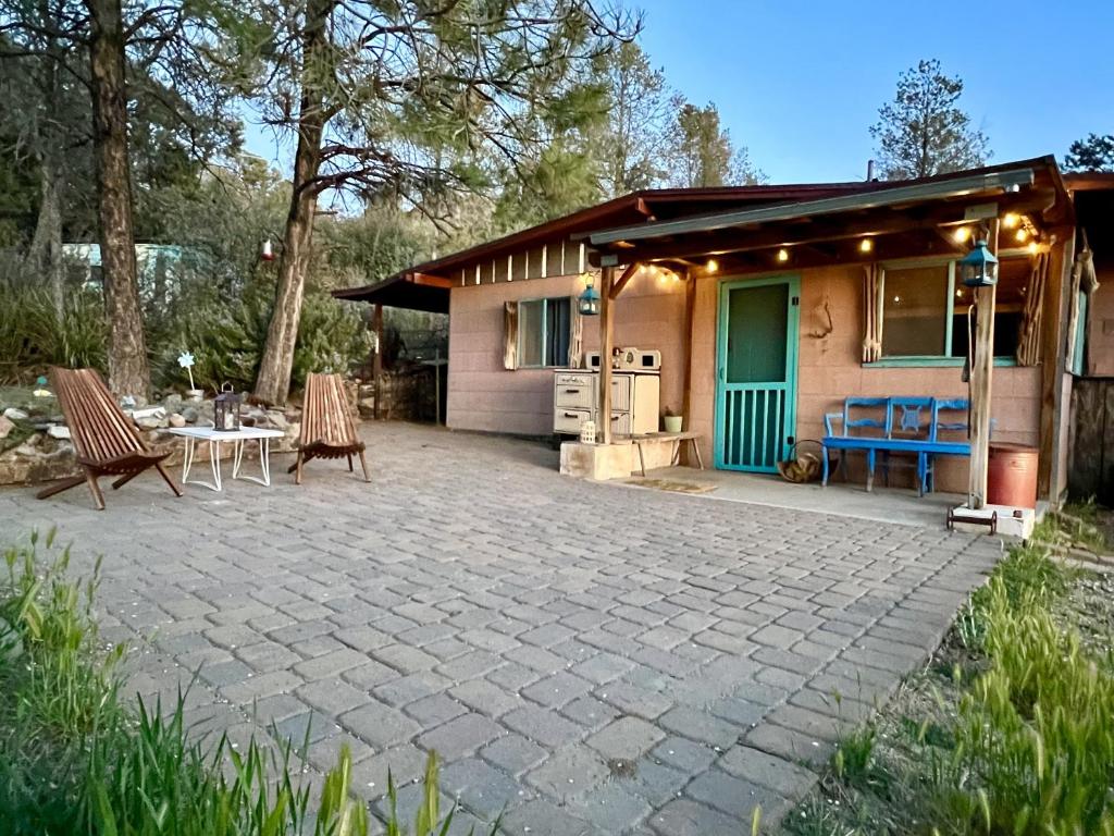 a patio in front of a house with a table and chairs at Lookout Cabin in Prescott
