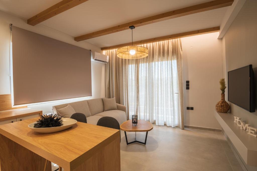 a living room with a couch and a table at Palaia Luxury Suite in Volos