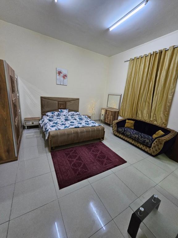 a bedroom with a bed and a couch in it at استوديو مفروس in As Sād