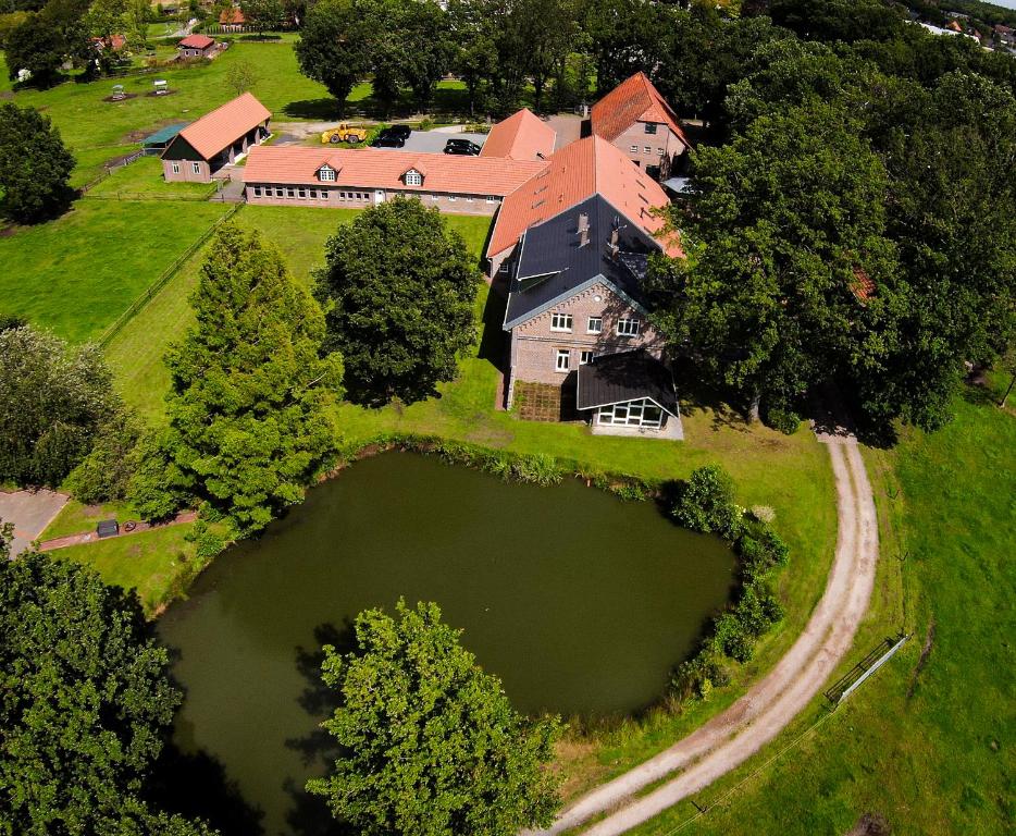 an aerial view of a large house with a large pond at Landgut Rastede Hostemost in Rastede