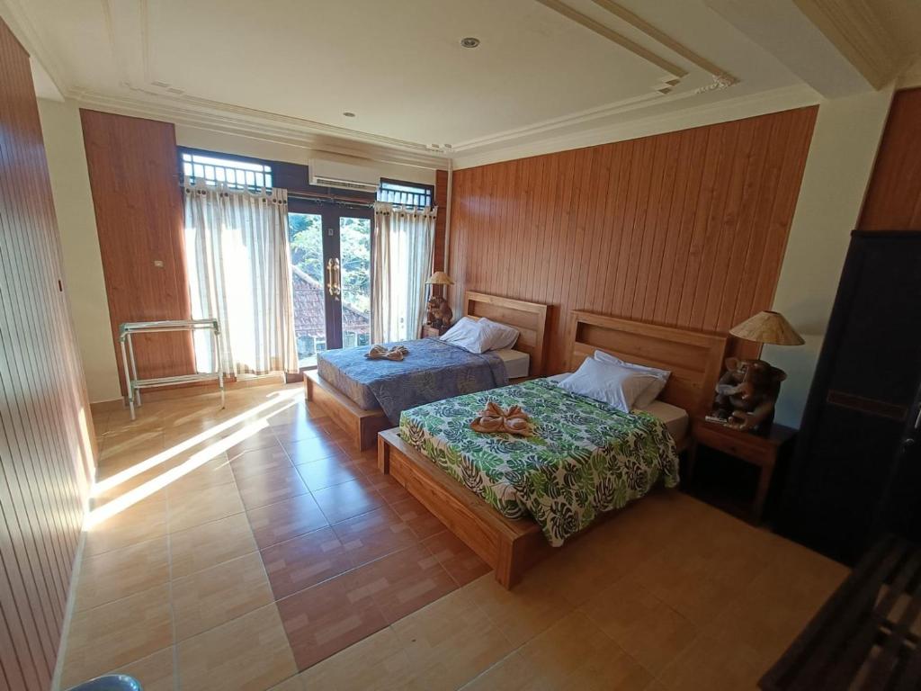 Postel nebo postele na pokoji v ubytování wahyu accomodation
